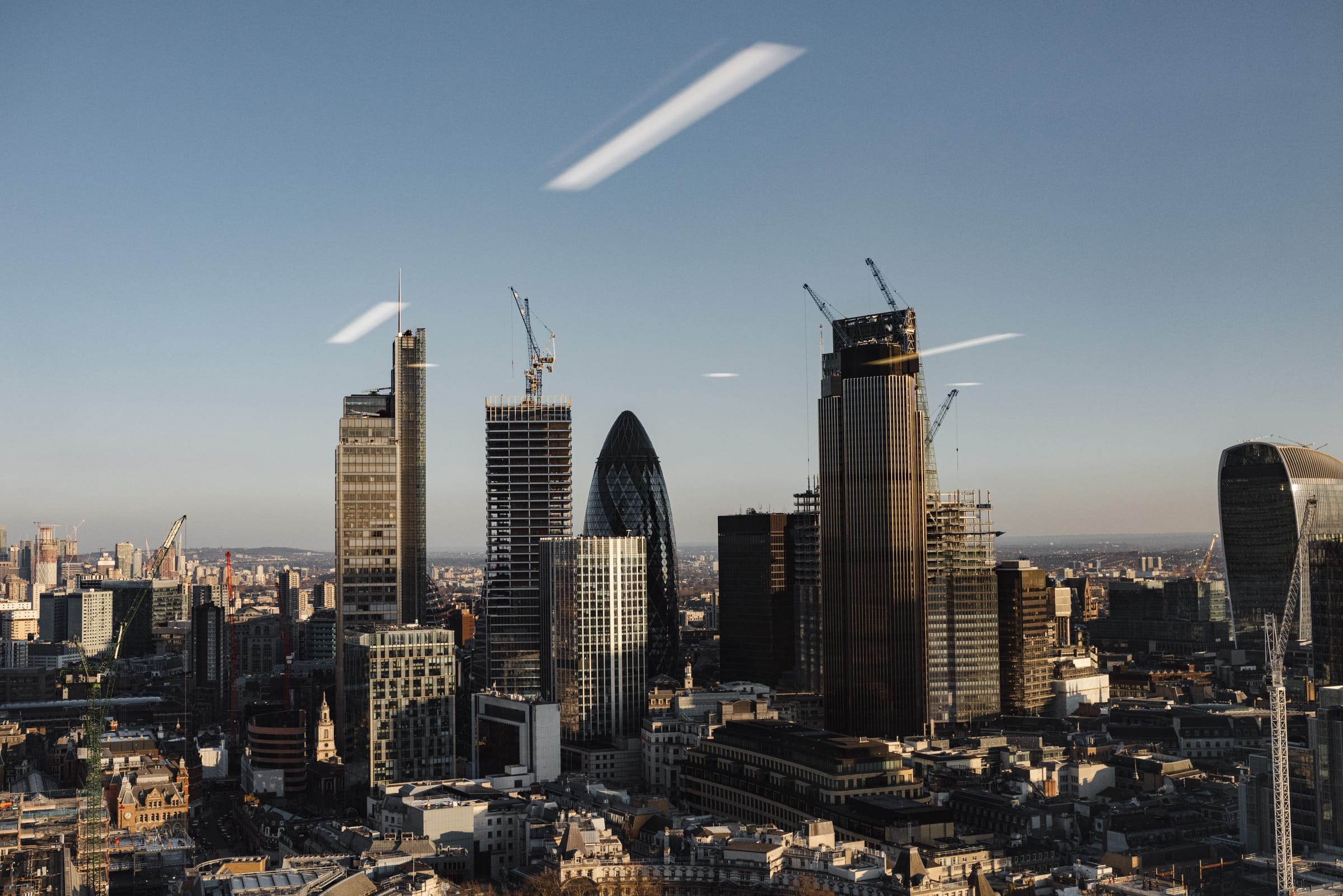 Aerial view of the City of London skyline and the River Thames at golden hour